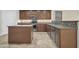 A kitchen featuring wooden cabinets, granite counters, and stainless steel appliances offers style and functionality at 17429 W Red Bird Rd, Surprise, AZ 85387