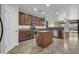 Kitchen with an island, stainless appliances, granite counters and access to the backyard at 17429 W Red Bird Rd, Surprise, AZ 85387