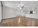 Spacious living room with hardwood floors, ceiling fans, and abundant natural light at 17429 W Red Bird Rd, Surprise, AZ 85387