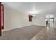 Spacious room with neutral tones and a mix of carpet and tile flooring at 17429 W Red Bird Rd, Surprise, AZ 85387