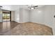 Open living space with tile and wood flooring and sliding door access to yard at 17429 W Red Bird Rd, Surprise, AZ 85387