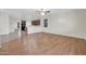 Open-concept living room with hardwood floors and a view of the kitchen at 17429 W Red Bird Rd, Surprise, AZ 85387