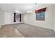 Inviting living space with neutral carpet, tile flooring, and natural light at 17429 W Red Bird Rd, Surprise, AZ 85387