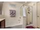 Clean bathroom featuring a shower with glass doors and a separate tub with tile surround at 18415 W Surprise Farms N Loop, Surprise, AZ 85388