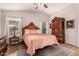 Cozy bedroom featuring hardwood floors, a carved wood bed frame, and ample natural light at 18415 W Surprise Farms N Loop, Surprise, AZ 85388