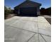 Home featuring a spacious concrete driveway leading to an attached two-car garage at 18415 W Surprise Farms N Loop, Surprise, AZ 85388