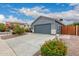 A well-maintained home with desert landscaping, a two-car garage, and a clean, modern exterior design at 18415 W Surprise Farms N Loop, Surprise, AZ 85388