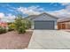 Charming single-story home featuring desert landscaping and a two-car garage, perfect for first-time homebuyers at 18415 W Surprise Farms N Loop, Surprise, AZ 85388