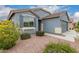 Inviting exterior with desert landscaping, shutters, and a neutral color scheme, offering a welcoming curb appeal at 18415 W Surprise Farms N Loop, Surprise, AZ 85388