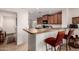 Well-lit kitchen featuring a breakfast bar, stainless steel appliances, and ample cabinet space for storage at 18415 W Surprise Farms N Loop, Surprise, AZ 85388