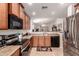 Well-lit kitchen featuring wood cabinetry, stainless steel appliances, and a functional layout at 18415 W Surprise Farms N Loop, Surprise, AZ 85388