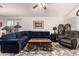 Spacious living room with tile floors, a plush sectional sofa, and a large area rug, great for entertaining guests at 18415 W Surprise Farms N Loop, Surprise, AZ 85388
