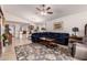 Open-concept living room featuring tile flooring, a comfortable sofa, and views into the dining and kitchen areas at 18415 W Surprise Farms N Loop, Surprise, AZ 85388
