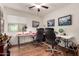 Bright home office setup with dual desks, hardwood floors, and natural light from the window at 18415 W Surprise Farms N Loop, Surprise, AZ 85388