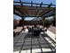 Pergola area showcasing comfortable seating with gravel yard and lush landscaping in the background at 18415 W Surprise Farms N Loop, Surprise, AZ 85388