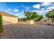 Backyard features gravel, potential garden space, and a view of the green space behind the property at 2111 E Azalea Dr, Chandler, AZ 85286