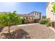 Backyard features gravel, concrete patio, orange tree, potential garden space for a customizable outdoor experience at 2111 E Azalea Dr, Chandler, AZ 85286