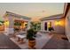 Backyard featuring green grass, covered patio with outdoor barbeque, fountain, and benches at 2111 E Azalea Dr, Chandler, AZ 85286