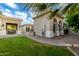 Home backyard featuring green grass, covered patio, tile roof, fountain, and trees at 2111 E Azalea Dr, Chandler, AZ 85286