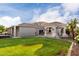 Home backyard featuring green grass, covered patio, tile roof, and view of house at 2111 E Azalea Dr, Chandler, AZ 85286