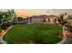 Manicured backyard with a large lawn, outdoor entertainment area, and mature trees, perfect for outdoor activities at 2111 E Azalea Dr, Chandler, AZ 85286