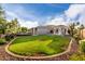 Expansive backyard features a lush lawn, covered patio, outdoor kitchen, and pool perfect for entertaining at 2111 E Azalea Dr, Chandler, AZ 85286