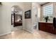 Beautiful bathroom featuring travertine tile, glass block window, and access to the main bedroom and toilet room at 2111 E Azalea Dr, Chandler, AZ 85286