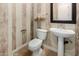 Stylish powder room with pedestal sink, decorative wallpaper, and elegant fixtures, offering a touch of luxury at 2111 E Azalea Dr, Chandler, AZ 85286