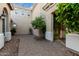 Picturesque courtyard featuring stone pavers, mature landscaping, and stucco walls, creating an inviting outdoor space at 2111 E Azalea Dr, Chandler, AZ 85286
