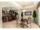 Elegant dining area featuring a glass-top table and ornate chairs next to an open-concept kitchen at 2111 E Azalea Dr, Chandler, AZ 85286