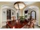 Formal dining room showcasing a large wooden table, ornate chandelier, and arched doorways for elegant gatherings at 2111 E Azalea Dr, Chandler, AZ 85286