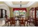 Elegant dining room features a wooden table, decorative hutch, and view of the outdoor patio, perfect for entertaining at 2111 E Azalea Dr, Chandler, AZ 85286