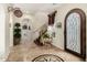 Elegant foyer boasts travertine floors, decorative wrought iron door, and staircase, creating a grand entrance at 2111 E Azalea Dr, Chandler, AZ 85286