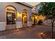 This arched front entrance features uplighting and a brick-paved courtyard at 2111 E Azalea Dr, Chandler, AZ 85286
