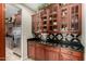 Kitchen with custom cabinets, granite countertops, stainless-steel refrigerator, and tile backsplash, offering modern style at 2111 E Azalea Dr, Chandler, AZ 85286