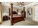 Luxurious main bedroom with a four-poster bed, elegant furnishings, and a tray ceiling at 2111 E Azalea Dr, Chandler, AZ 85286