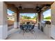 Covered outdoor kitchen with a grill, fireplace, and dining area, perfect for entertaining guests and enjoying meals at 2111 E Azalea Dr, Chandler, AZ 85286
