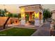 Inviting outdoor space with a covered patio, stone fireplace, and lush landscaping, designed for entertaining at 2111 E Azalea Dr, Chandler, AZ 85286
