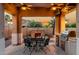 Outdoor patio featuring stone fireplace, table and chairs and bar seating with barbeque at 2111 E Azalea Dr, Chandler, AZ 85286
