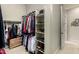 Spacious walk-in closet featuring rods for hanging clothes and multiple shelves for holding shoes and boots at 2111 E Azalea Dr, Chandler, AZ 85286