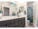 Bathroom features a shower and gray vanity with double sinks at 22495 E Silver Creek Ln, Queen Creek, AZ 85142