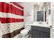 Stylish bathroom features a shower and gray vanity at 22495 E Silver Creek Ln, Queen Creek, AZ 85142