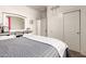 Bright bedroom features a sliding closet door and an ensuite bathroom at 22495 E Silver Creek Ln, Queen Creek, AZ 85142