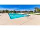 Large, resort-style community pool with multiple seating areas and manicured landscaping at 22495 E Silver Creek Ln, Queen Creek, AZ 85142
