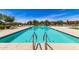 Community pool with a zero entry and plenty of lounge chairs around it at 22495 E Silver Creek Ln, Queen Creek, AZ 85142