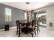 Modern dining area with contemporary light fixtures, a large table for seating, and access to outdoor living at 22495 E Silver Creek Ln, Queen Creek, AZ 85142
