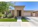 Charming home exterior featuring a well-manicured lawn and welcoming entrance, garage, and desert landscaping at 22495 E Silver Creek Ln, Queen Creek, AZ 85142
