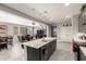 Open kitchen with a large island that flows into the dining and living areas at 22495 E Silver Creek Ln, Queen Creek, AZ 85142