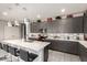Kitchen features gray cabinets, stainless appliances, and a large island perfect for cooking and entertaining at 22495 E Silver Creek Ln, Queen Creek, AZ 85142
