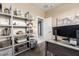 Bright home office features shelving and a modern desk setup at 22495 E Silver Creek Ln, Queen Creek, AZ 85142